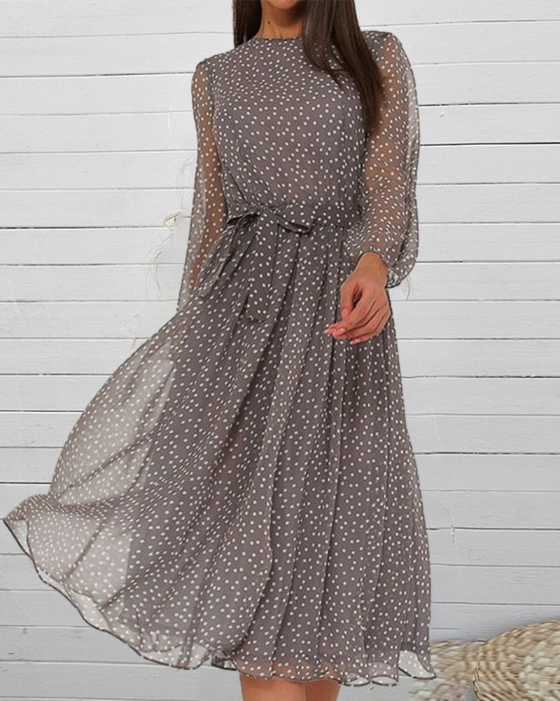 Chic women's polka dot A-line dress with long sleeves. Versatile knee-length style for elegant fall or spring fashion.