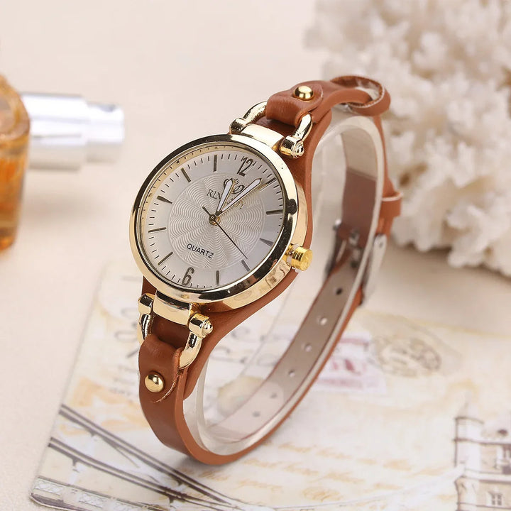 Elegant women's quartz watch with intricately engraved dial and cruelty-free vegan leather strap.