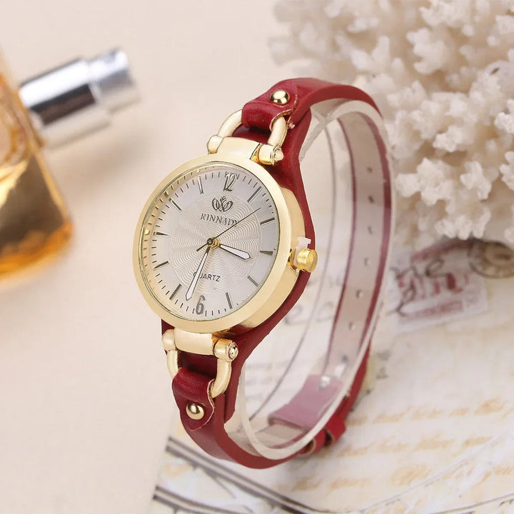 Fashionable women's accessory: quartz watch featuring an engraved dial and comfortable vegan leather strap.