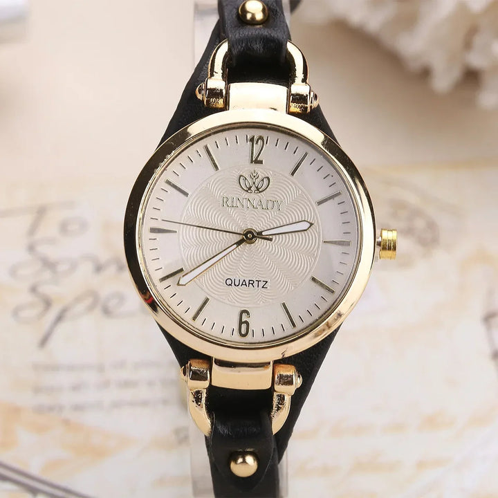 Women's elegant quartz watch with a detailed engraved dial and stylish vegan leather strap for daily wear.