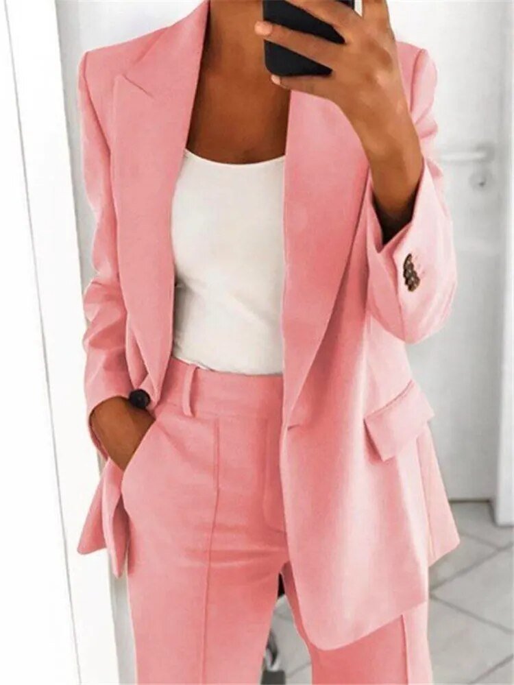 Stylish women's relaxed fit two-piece suit, elegant blazer & trousers for comfortable professional wear.