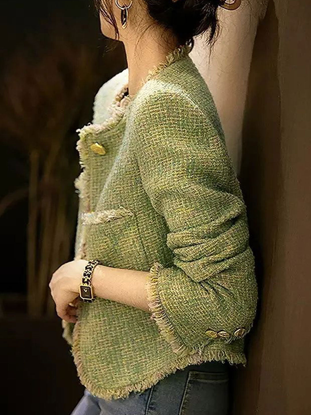 Close-up of a versatile women's elegant tweed jacket, highlighting its classic texture & formal style.