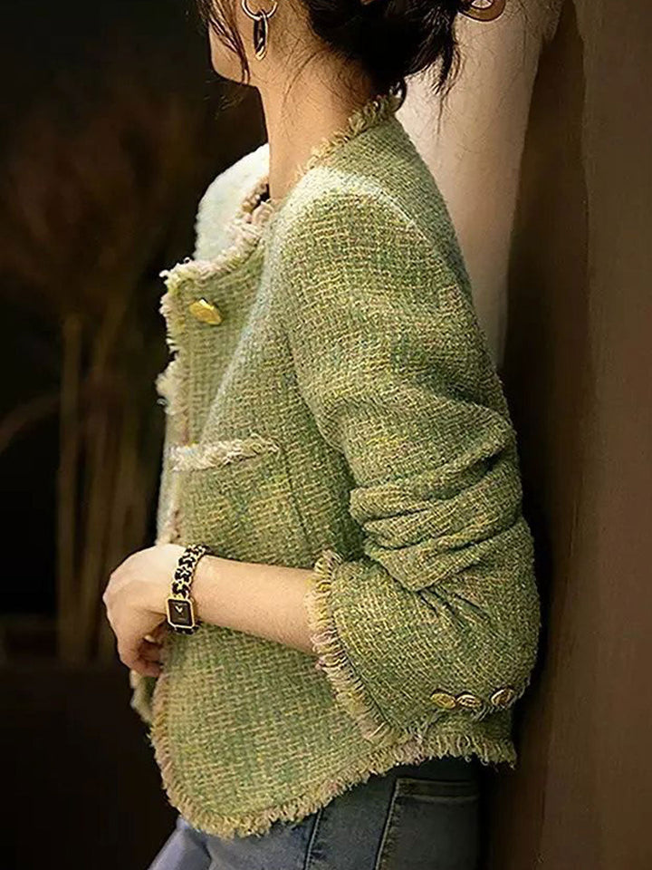 Close-up of a versatile women's elegant tweed jacket, highlighting its classic texture & formal style.