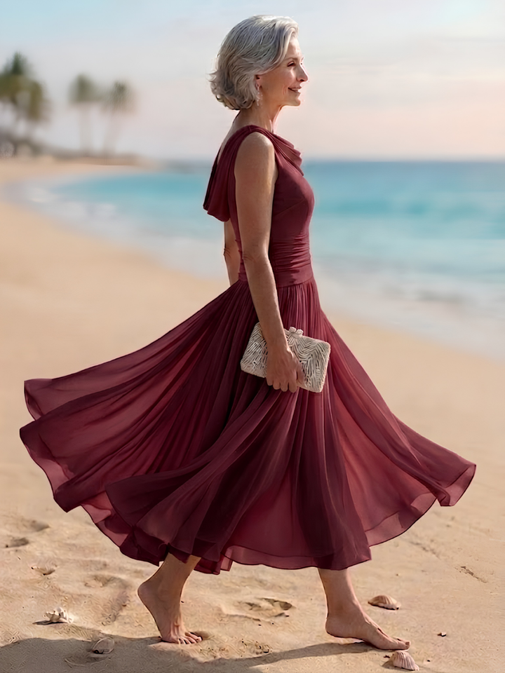 Chic women's sleeveless A-line midi dress. Pleated, draped neck, perfect elegant wedding guest attire.