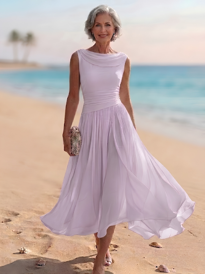 Stylish women's pleated A-line midi dress. Draped neckline, sleeveless, ideal for formal spring/summer parties.