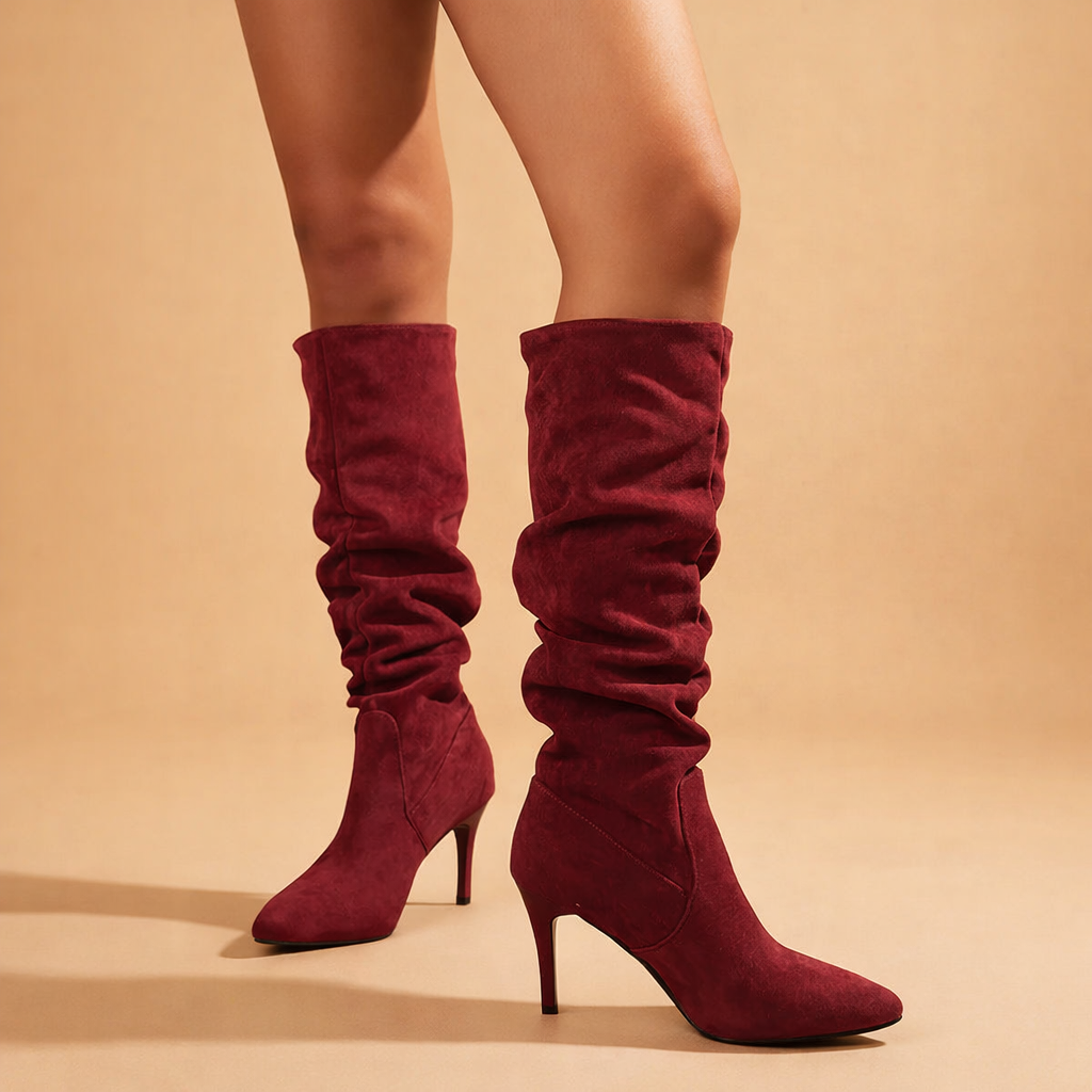 Elegant women's slouch knee-high heeled boots. Modern fall & winter fashion footwear.