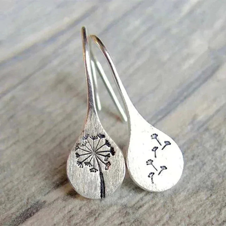Elegant women's sterling silver dandelion teardrop dangle earrings. Unique handcrafted floral jewelry, perfect gift for her.