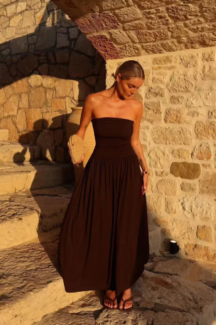Stylish women's brown strapless maxi dress, featuring elegant pleats, suitable for any special event.