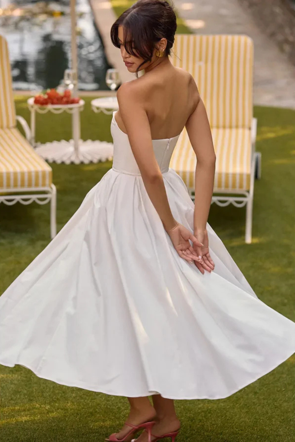 Stylish women's midi dress featuring a structured strapless corset bodice and a graceful flared skirt silhouette.