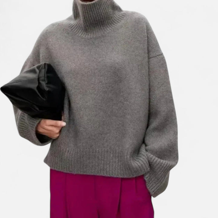 Cozy women's long-sleeve turtleneck sweater, elegant and warm knitwear for classic winter fashion.