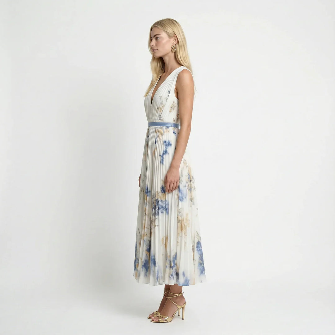 Detailed view of delicate floral pattern and flowy pleats on a women's V-neck summer maxi dress.