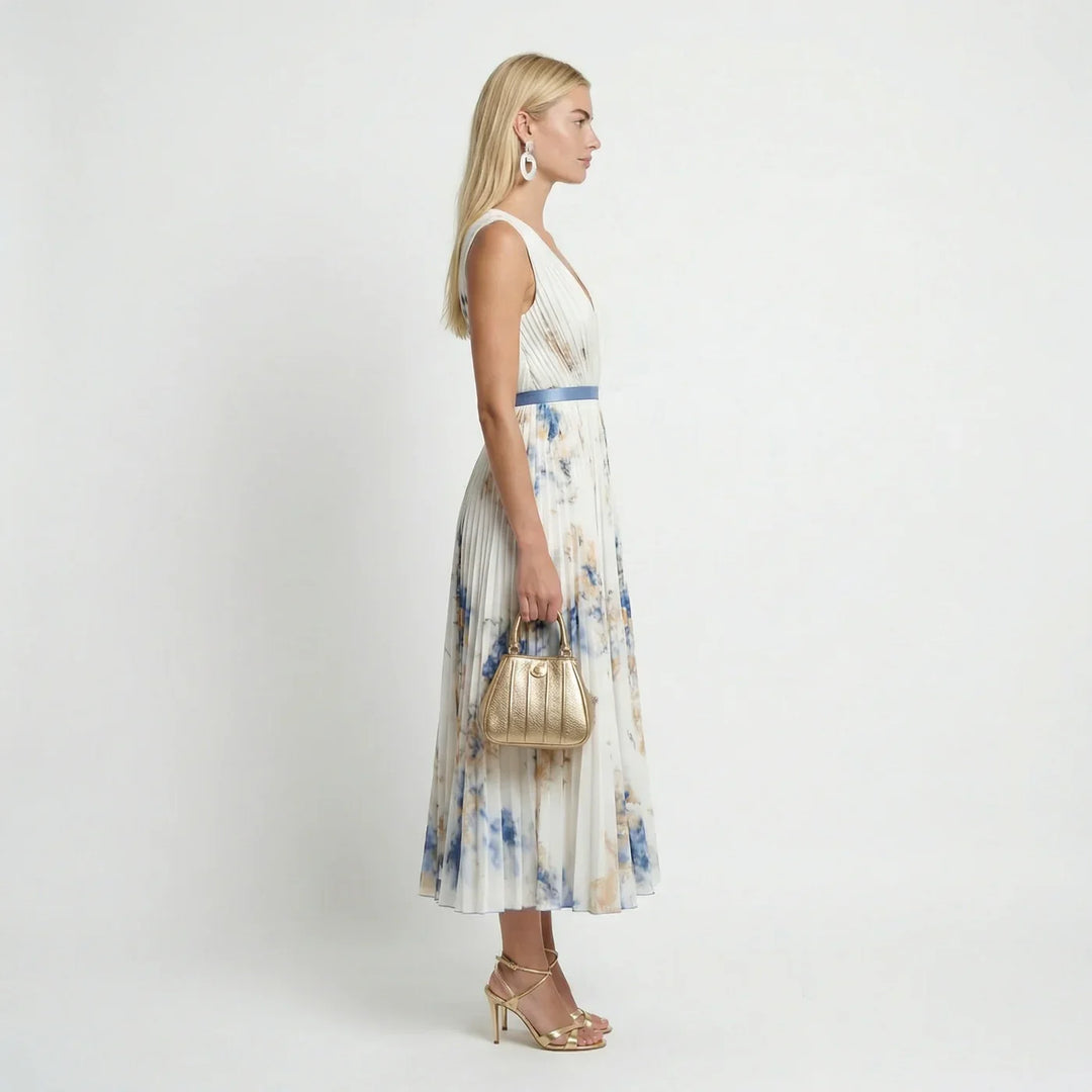 Flowy back view of a sleeveless floral pleated maxi dress for women, perfect for summer holidays.