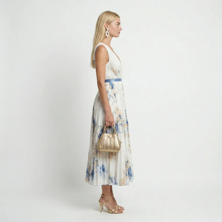 Flowy back view of a sleeveless floral pleated maxi dress for women, perfect for summer holidays.