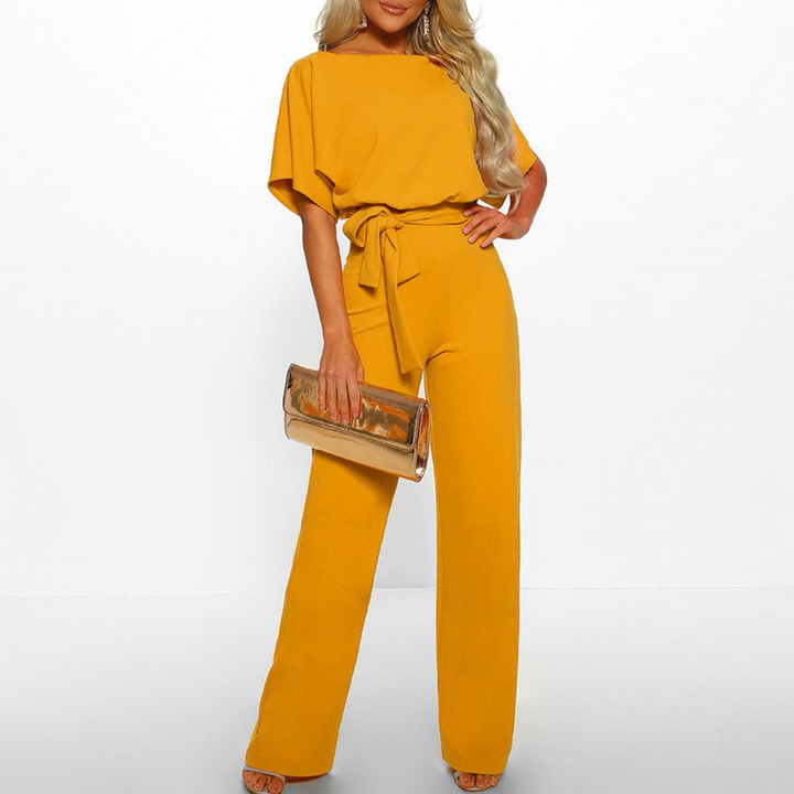 Full-length view of a women's wide leg jumpsuit with graceful flutter sleeves, perfect for formal fashion.