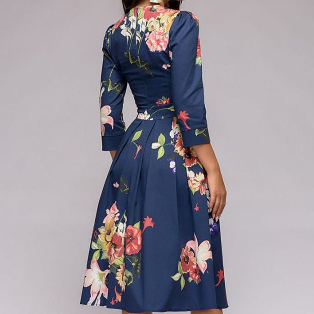 Women's A-line dress in red floral print, 3/4 sleeves and knee-length hem.