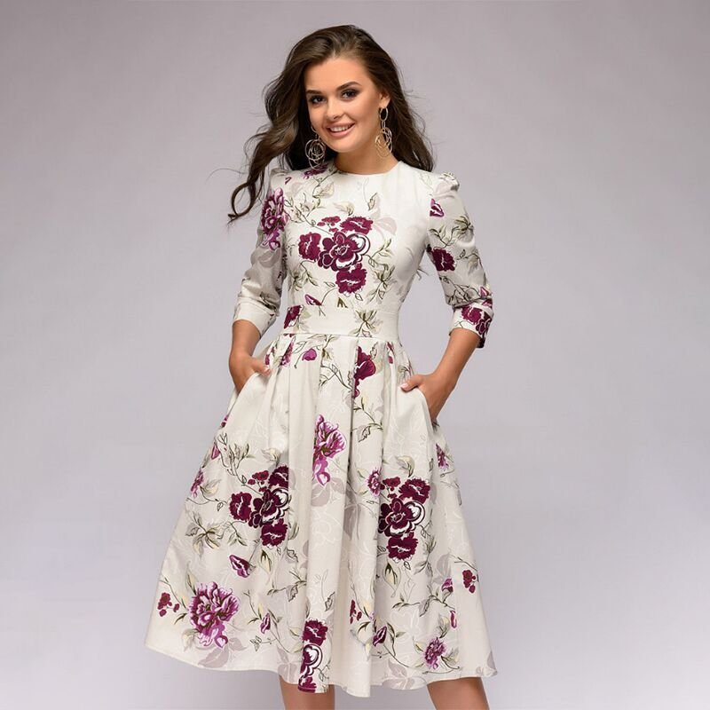 Women's A-line dress in navy blue with floral print, 3/4 sleeves and knee-length hem.