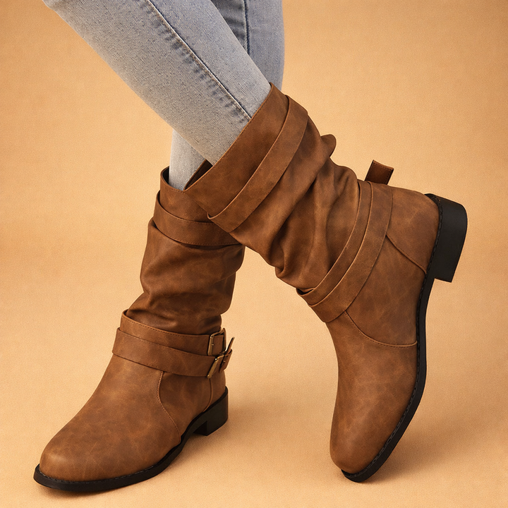 Black women's buckle mid-calf boots. Comfortable, chic winter footwear for stylish everyday and elegant outfits.