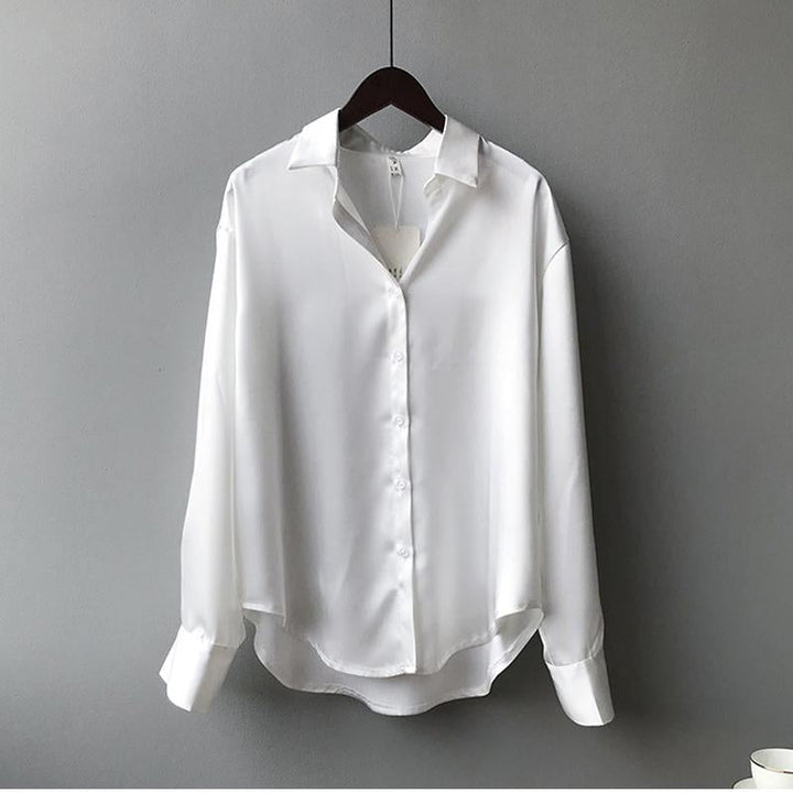 Elegant women's fall blouse in luxurious silk, soft and classic design, perfect for versatile styles and chic silhouettes.