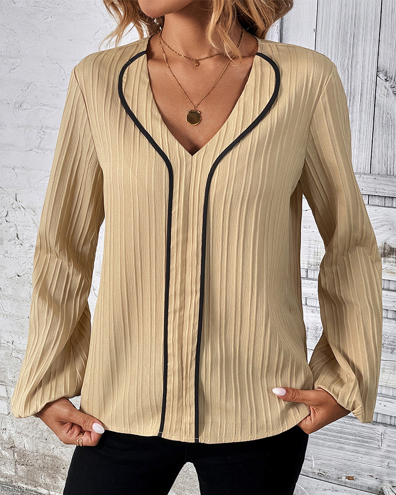 Elegant women's V-neck top with stylish balloon sleeves in a solid color, perfect for chic office wear.