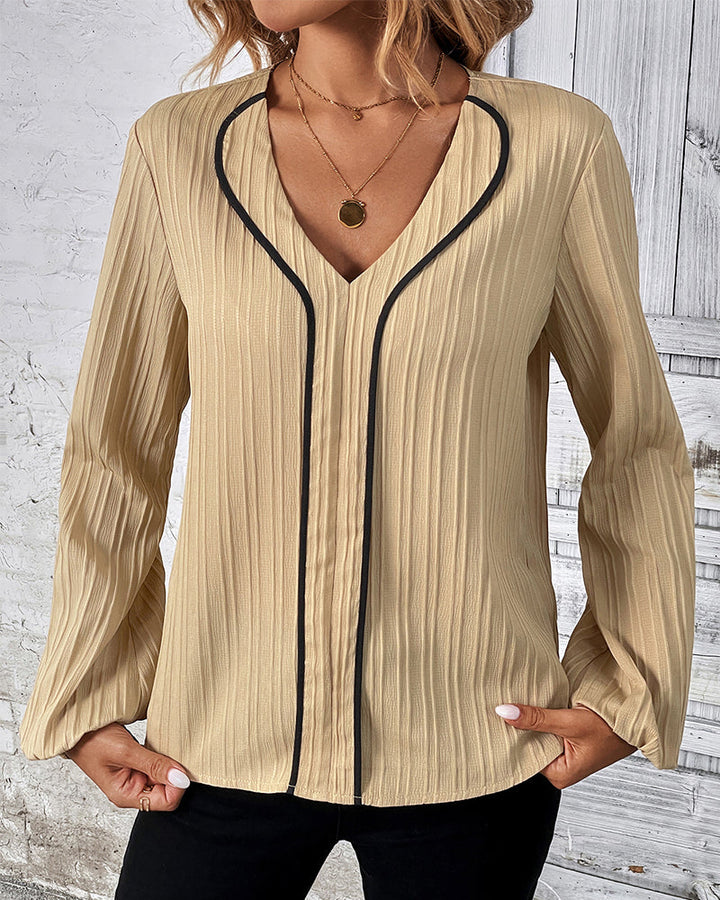 Elegant women's V-neck top with stylish balloon sleeves in a solid color, perfect for chic office wear.