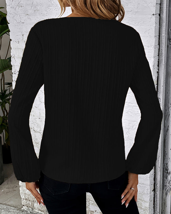 Women's elegant V-neck top with billowy balloon sleeves and a flattering fit, essential for any wardrobe.