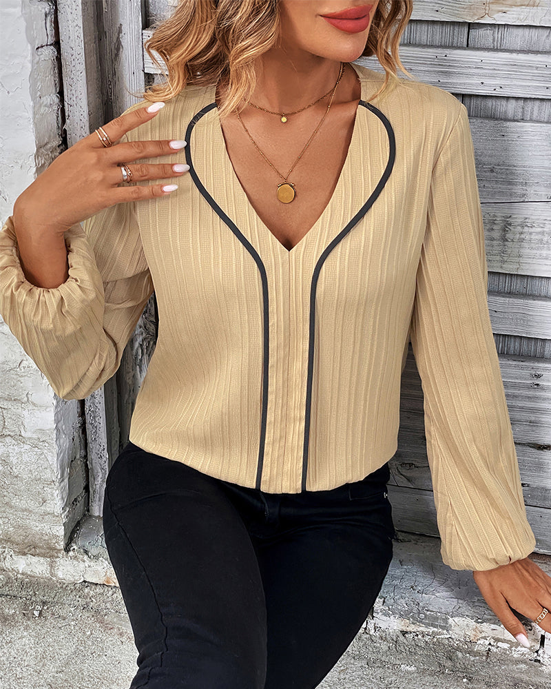 Chic women's V-neck blouse with elegant balloon sleeves. A solid color top for versatile casual & office looks.