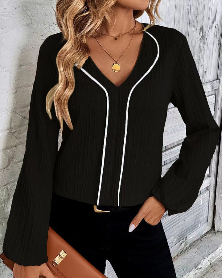 Stylish women's long sleeve V-neck top featuring trendy balloon sleeves, ideal for everyday fashion.