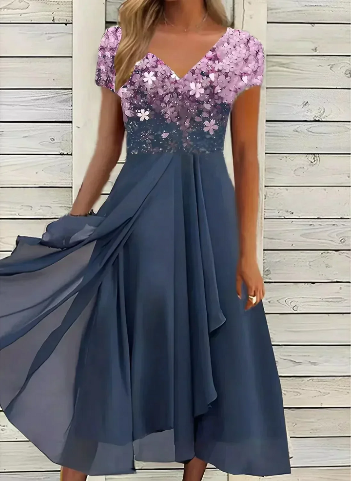 Shimmering silver elegant V-neck gown for women. Perfect long formal dress for a special occasion.