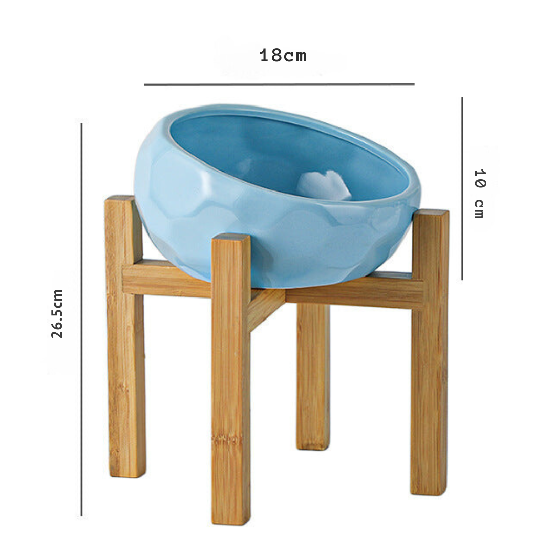 "Ergonomic elevated pet bowl with non-slip wooden stand, sleek design, blue color, enhances pet comfort and posture."