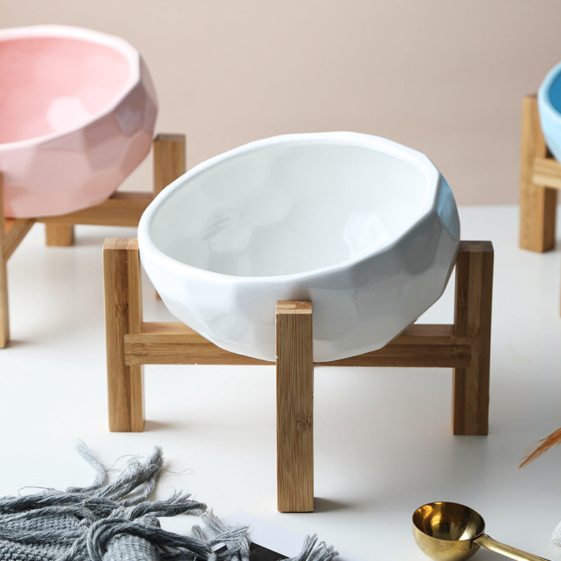 "Ergonomic elevated pet bowl with non-slip wooden stand, sleek design, blue color, enhances pet comfort and posture."