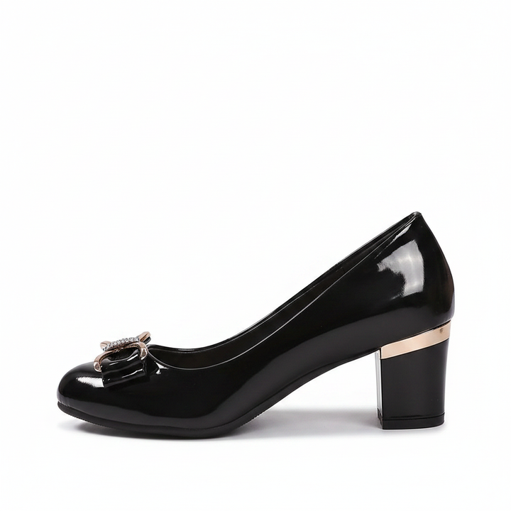 Women's black block heel pumps with elegant bow detail.