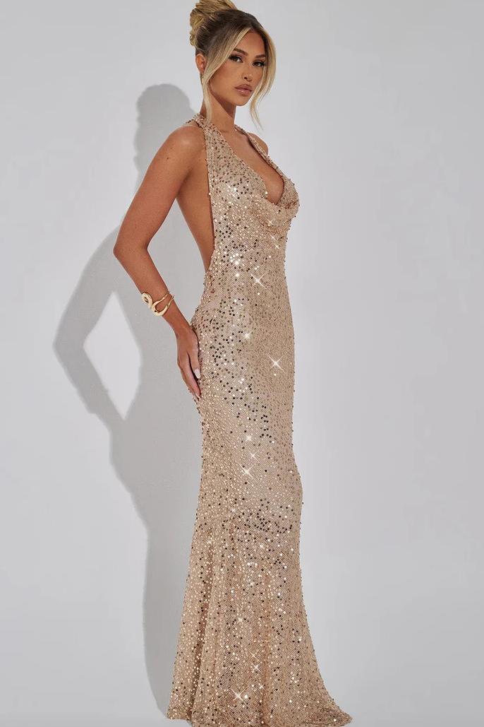 Luxurious women's sequin evening gown, halter neck, open back. A glamorous long party dress.