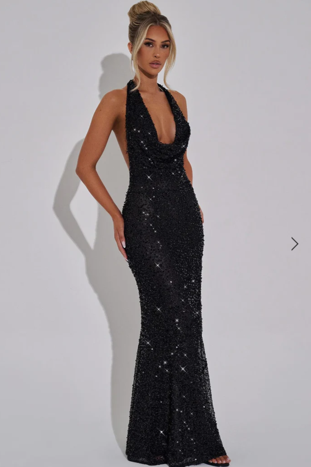 Glamorous women's sequin halter neck maxi dress, open back, perfect for evening parties.