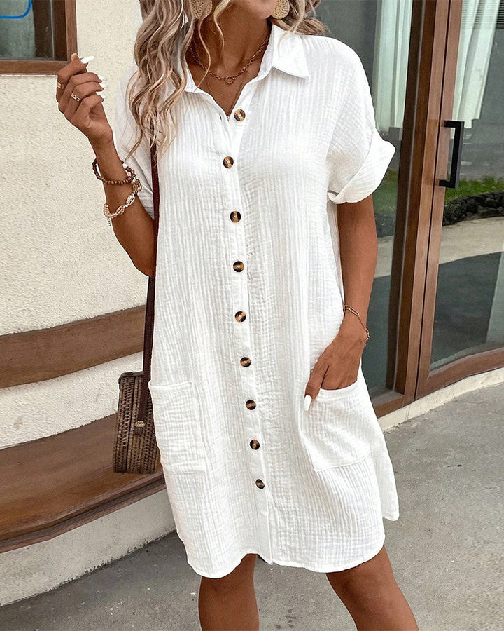 Lightweight women's summer mini dress. Collared, button-front, and short-sleeved for effortless warm weather fashion.