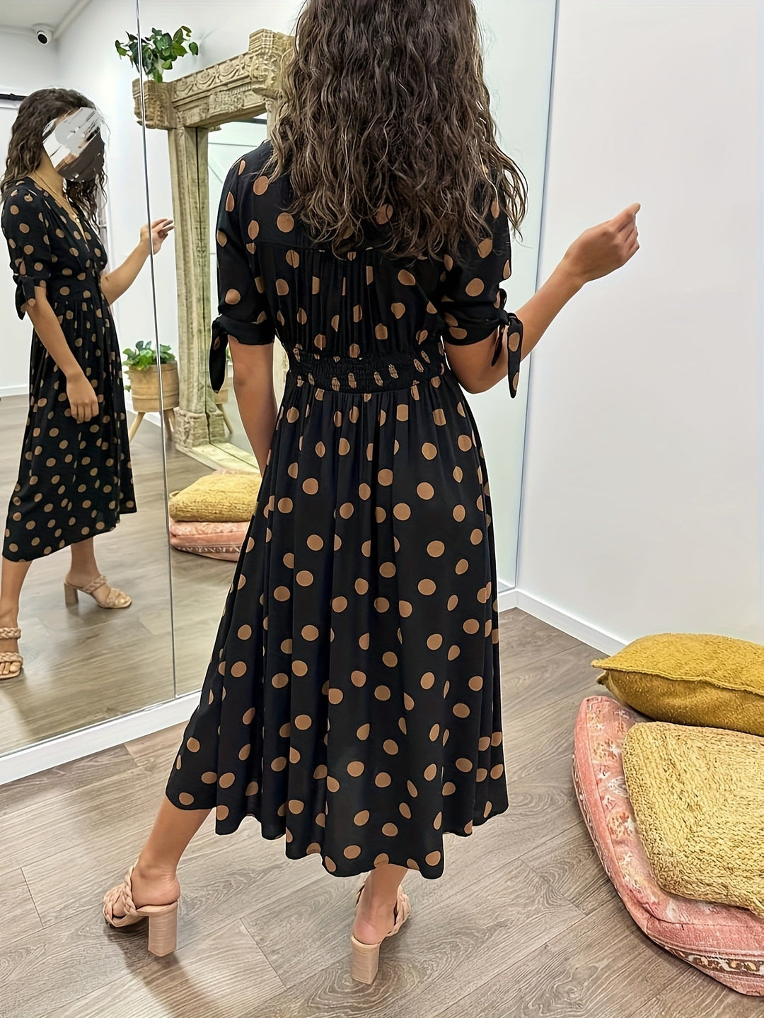 Chic women's black polka dot midi dress, a versatile piece for effortless style and occasion wear.