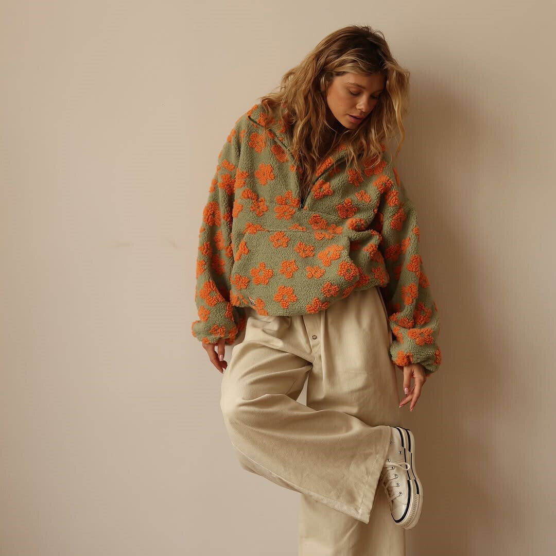 Chic women's floral quarter zip sweater, featuring a cozy design and a stylish long sleeve pullover cut.