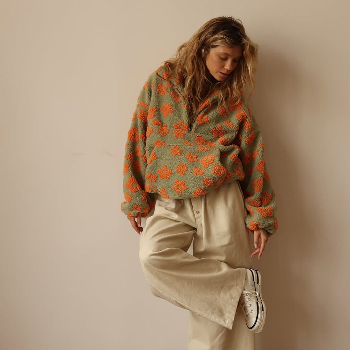 Chic women's floral quarter zip sweater, featuring a cozy design and a stylish long sleeve pullover cut.