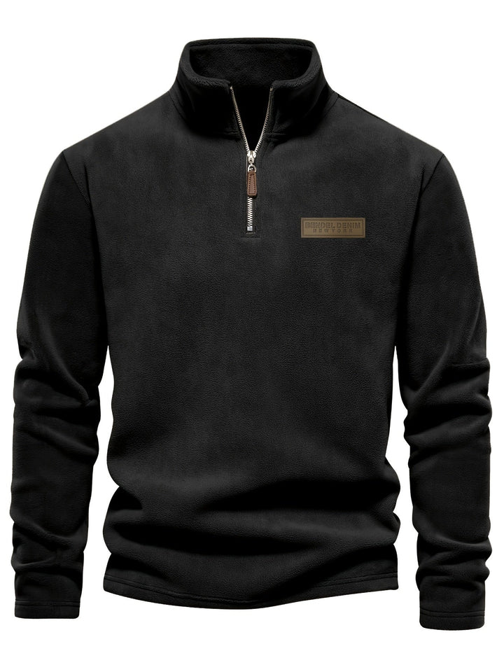 Detail shot of a cozy unisex half-zip pullover, showcasing the soft fleece lining and warm fabric.