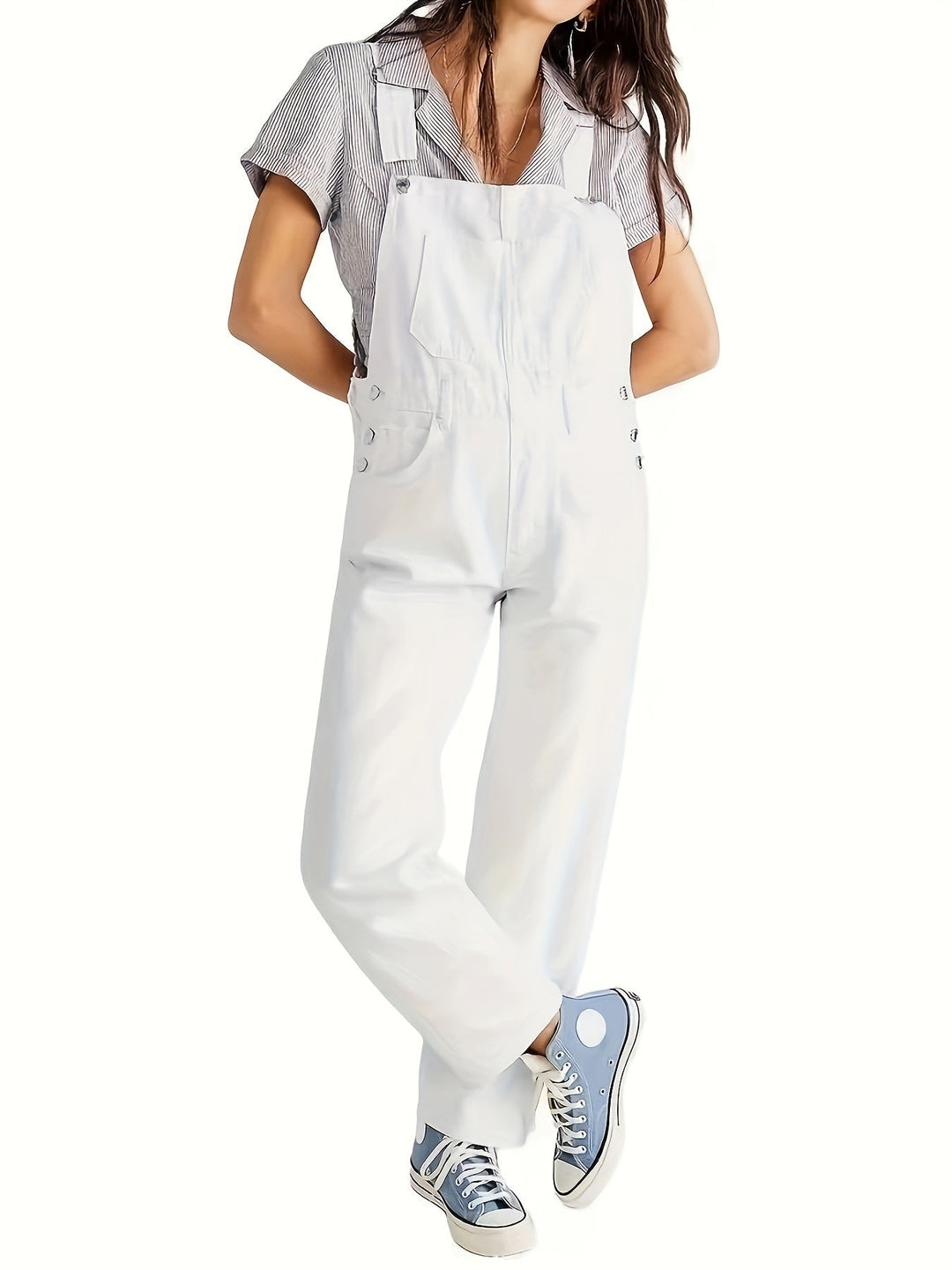 Close-up of the durable blue denim fabric texture of women's loose fit dungarees, comfy overalls.