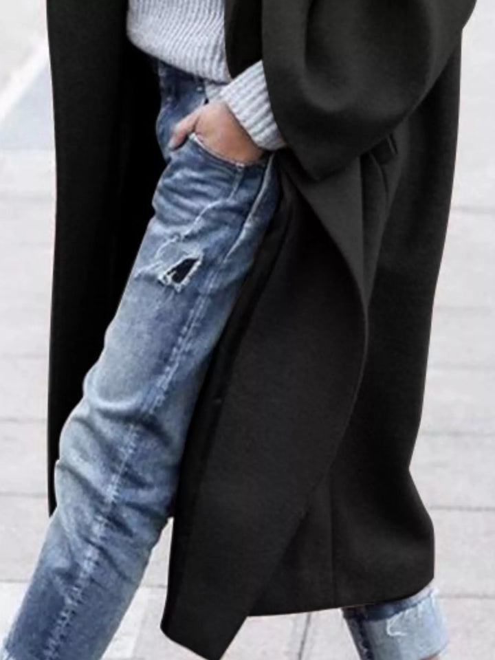 Warm black oversized women's winter jacket, a comfortable long coat for cold-weather elegance.