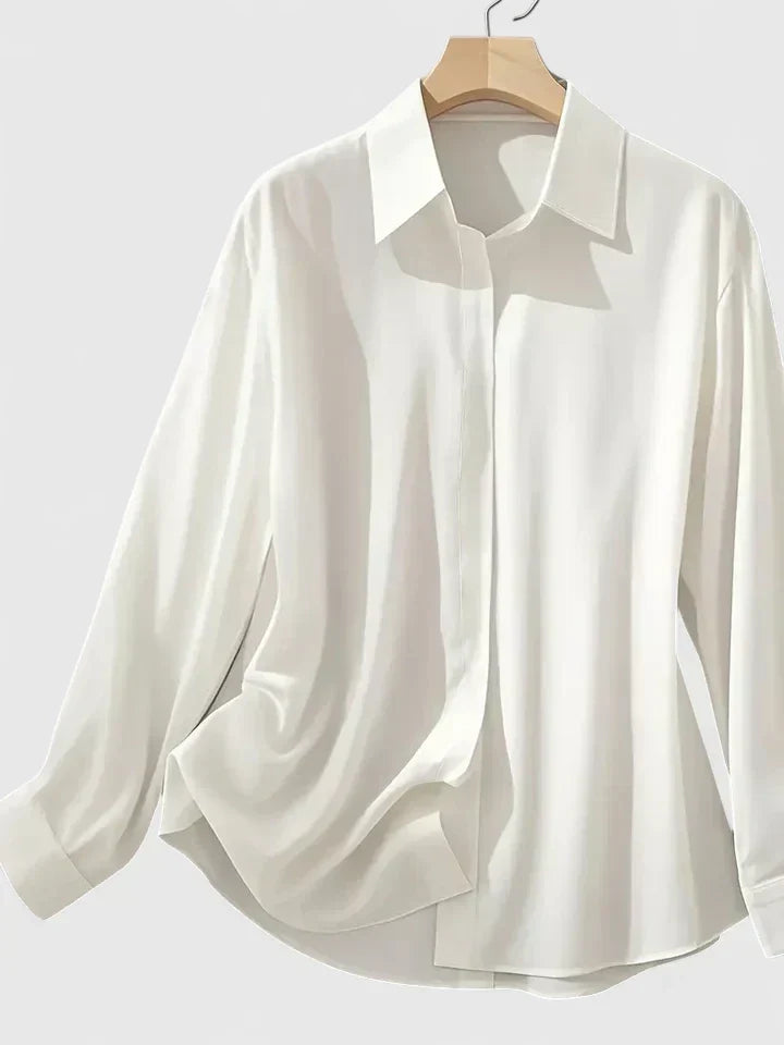 Elegant women's button-down blouse, perfect for office or casual chic. Long sleeve, curved hem top.
