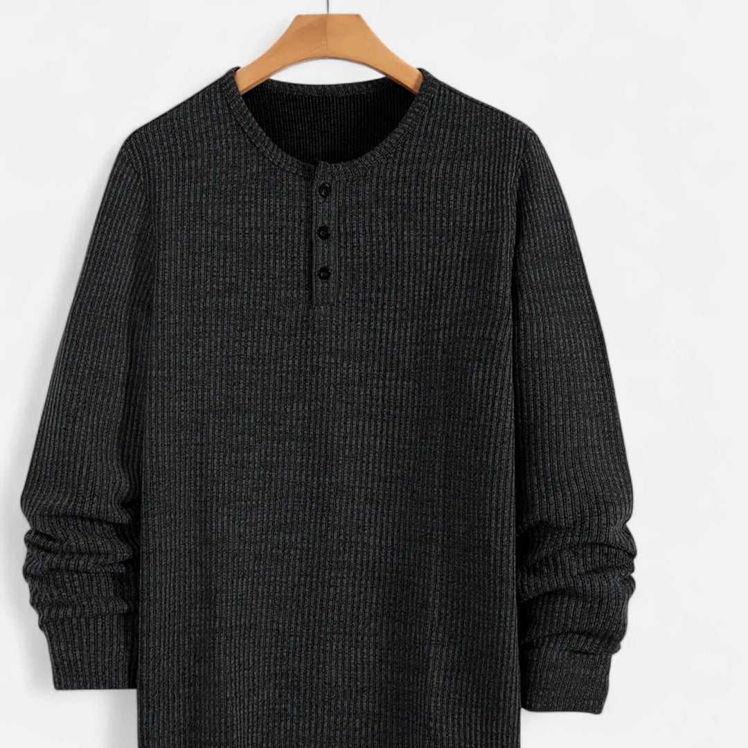 Men's long-sleeve cable-knit henley sweater. A versatile and warm layering piece for cooler seasons.