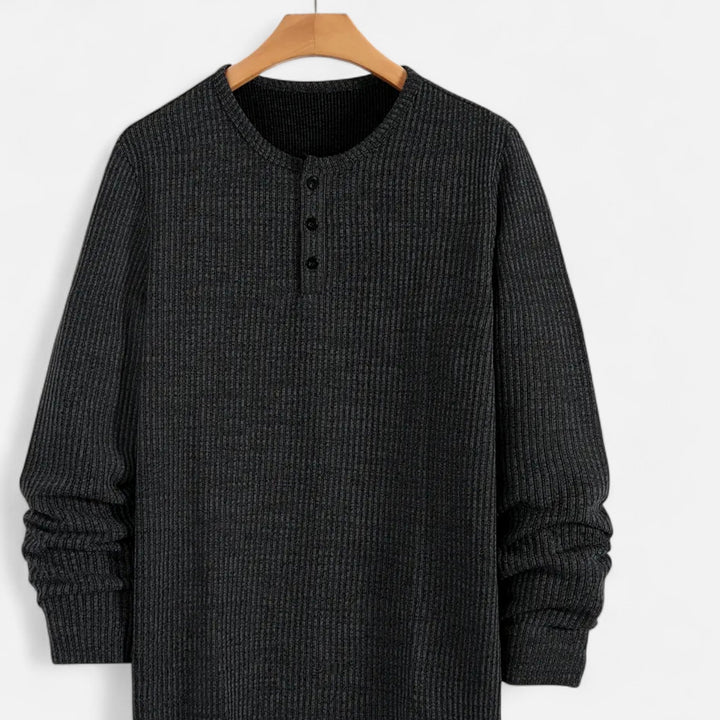 Men's long-sleeve cable-knit henley sweater. A versatile and warm layering piece for cooler seasons.