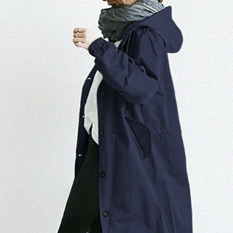 Oversized women's hooded raincoat, stylish design for all-weather outdoor use.