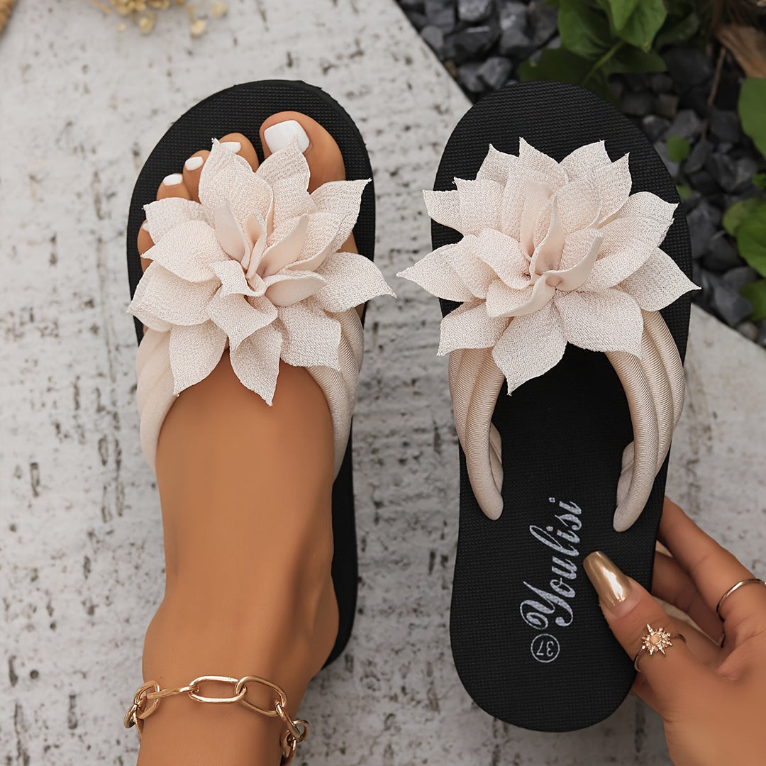 Comfortable women's wide fit platform flip-flops with elegant flower accents.
