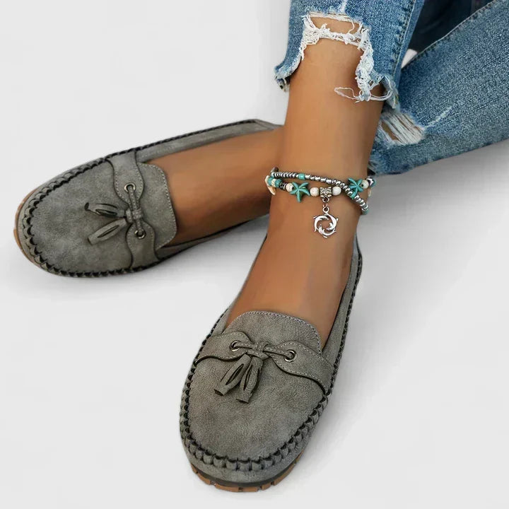 Stylish women's slip-on loafers with chic tassel detail, perfect for smart casual & professional outfits.