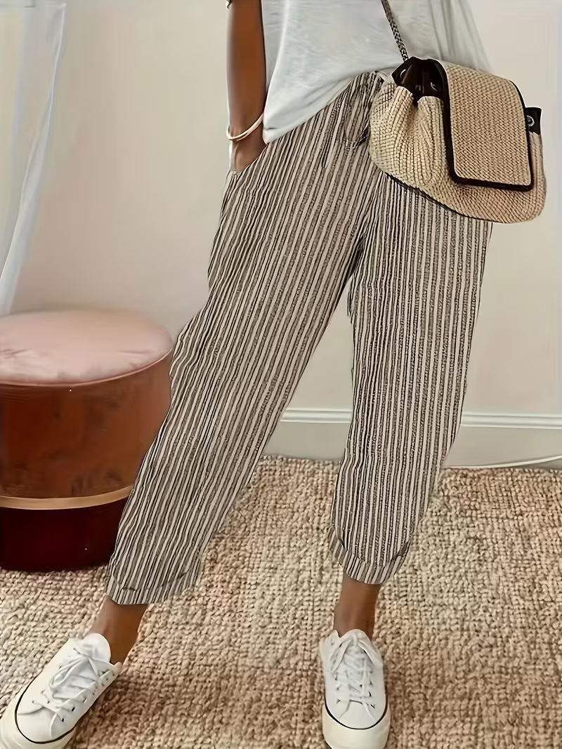Comfortable women's wide-leg casual pants featuring a stylish vertical stripe pattern and elastic waist.