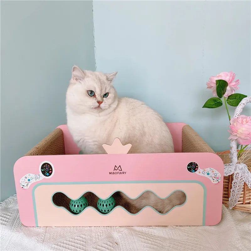 Multi-functional pink cat scratcher box with a sisal board and attached toy, ideal for cat comfort and play area.