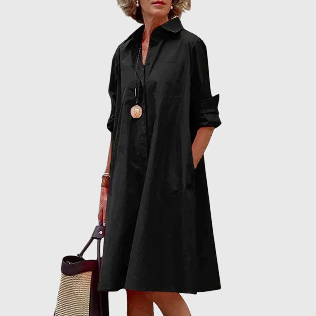 Back view of a flowing women's everyday dress, displaying its elegant drape and chic fashion.
