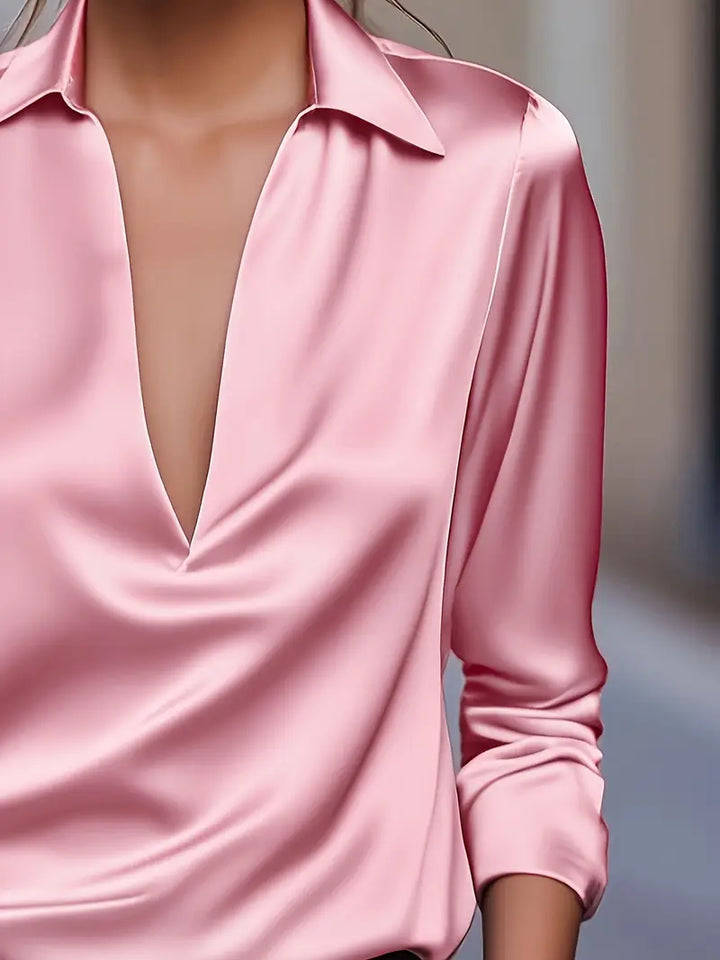 Women's collared V-neck top, long sleeves. A stylish and comfortable blouse for any professional or casual setting.